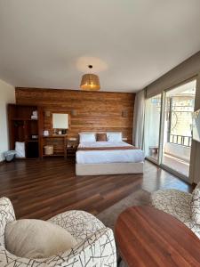 a large bedroom with a bed and wooden walls at Elevana Boutique hotel in Cairo