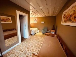 a room with a bedroom with a bed and a mirror at Pousada Chateau Bella Vista in Campos do Jordão +43 photos