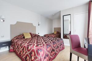 Un ou plusieurs lits dans un hébergement de l'établissement Hotel Montpensier