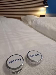 a pair of twin beds with their labels on them at Double Room 8 on pedestrian street Saeby in Sæby