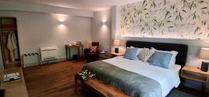 a bedroom with a bed with a large painting on the wall at Mili's B&B Guest House in Gabrovo