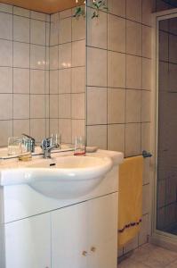 a bathroom with a white sink and a shower at Lina et Anaë in Saint-Nabor +28 photos