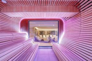 a room with a pink wall with a mirror at Tavel Hotel & SPA in Bukovel