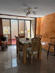 a dining room with a wooden table and chairs at El Palmar in Palmira