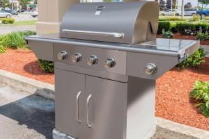 a barbecue grill with a grill top on a street at Super 8 by Wyndham Guelph in Guelph