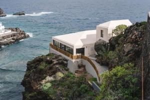 a house on a cliff next to the ocean at Villa Vista Suite by Aura Collection in Tamaduste