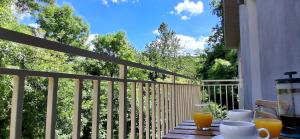 a table with two glasses of orange juice on a balcony at Mili's B&B Guest House in Gabrovo