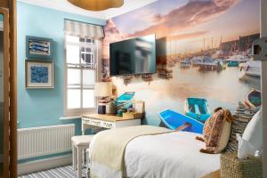a bedroom with a wall mural of a marina at The Royal Lion Hotel in Lyme Regis