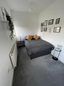 a bedroom with a bed and a tv in it at 2 bed- walkable train and beach apartment in Crosby
