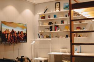 a room with white shelves and a painting on the wall at The ALL-in-ONE LOFT with AIRPORT pickup in Ulaanbaatar