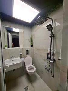 a bathroom with a toilet and a sink at Къща за гости Стил in Kiten +13 photos