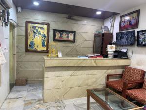 a room with a counter and two chairs and a table at Raya's Executive Homes in Kumbakonam