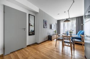 a kitchen and dining room with a table and chairs at Mechelinki Enjoy in Mechelinki +7 photos
