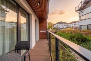 a balcony with chairs and a view of a city at Mechelinki Enjoy in Mechelinki