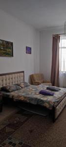 a bedroom with a large bed in a room at GGG FLAT a in Dobrovelychkivka