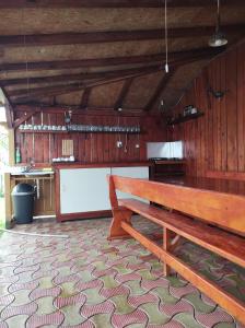 a wooden bench sitting in a room with a counter at casa Olga 2 Mai in 2 Mai