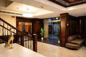 a living room with a staircase and a chair at Alasha Retreat in Srinagar