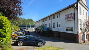 a row of cars parked in front of a building at Rodmay Heritage Hotel in Powell River