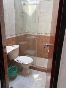 a bathroom with a toilet and a glass shower at El Palmar in Palmira +29 photos