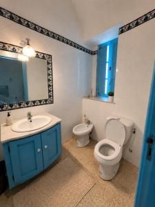 a bathroom with a toilet and a sink and a mirror at Casa Giallo Kelibia - Traditional charm in Kelibia