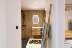 a bathroom with a sink and a mirror at Sun et Sea Dreams in Anse Marcel 