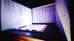 a small bed in a room with a window at Cabana dos sonhos Chalé experience Hidro CinemaSPA in Mateus Leme
