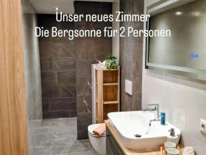 a bathroom with a sink and a toilet with the words unseen neumsimme at Lampererhof in Sankt Johann in Tirol +75 photos