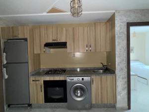 a kitchen with a washing machine and a sink at smir park Mdiq in M'diq
