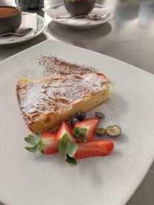 a plate of food with a piece of bread and fruit at Albergo Santa Maria in Esino Lario