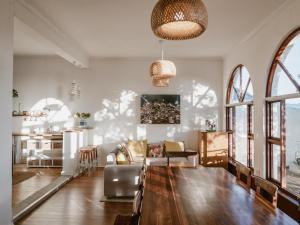 a living room with a couch and a table at Bonne Esperance, Simon's Town in Simonʼs Town