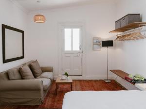 a living room with a couch and a table at Bonne Esperance, Simon's Town in Simonʼs Town