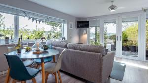 a living room with a table and a couch at Bilidowcar in Menai Bridge