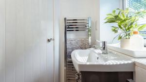 a bathroom with a sink and a mirror at Bilidowcar in Menai Bridge +75 photos