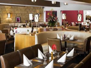 a restaurant with tables and chairs with napkins on them at Mercure Shéhérazade Rabat in Rabat
