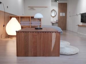 a wooden table with a lamp on it in a room at 泊寓 boyü in Lukang +24 photos
