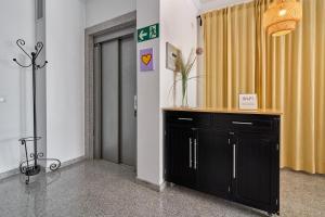 a room with a black cabinet and a yellow curtain at Apartamentos Nerjaluna in Nerja +234 photos