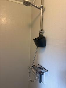 a light on a wall with a camera in a bathroom at Hus Rusken in Stockaryd +44 photos