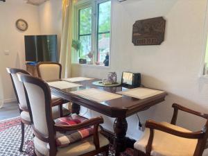 a dining room with a table with chairs and a television at Hus Rusken in Stockaryd