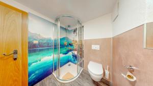 a bathroom with a shower with a painting on the wall at Appartement Belmonte in Sölden