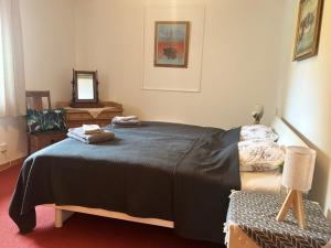 a bedroom with a bed with two towels on it at Hus Kalvsjö in Kalv