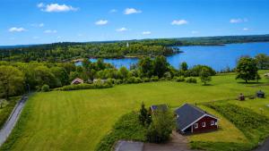 an aerial view of a house in a field next to a lake at Hus Kalvsjö in Kalv