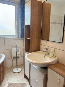 a bathroom with a sink and a mirror at Hus Kalvsjö in Kalv +35 photos