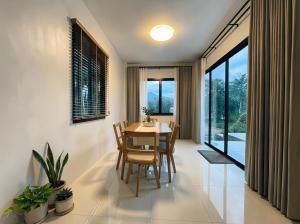 a dining room with a table and chairs at Nirvana Phangan Villas - Luxury & Serenity in Wok Tum