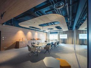 a meeting room with a long table and chairs at Mercure Troyes Centre in Troyes