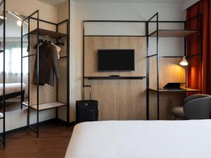 a room with a bed and a tv and a bedroom at ibis Paris Gare de Lyon Diderot in Paris