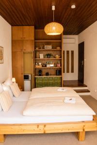 a bedroom with a large bed with a wooden ceiling at Mountain View Room mit sonnigem Wintergarten in Dietmannsdorf bei Trieben