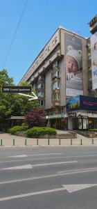 a large building with a billboard of a baby at MM Central Apartment with Parking in Skopje