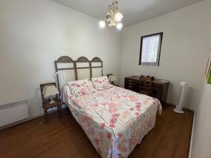a bedroom with a bed and a table and a window at La Maison Vieille in Peillon