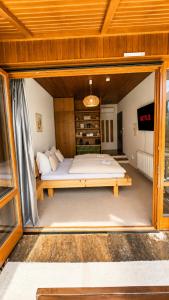 a bedroom with a large bed in a room at Mountain View Room mit sonnigem Wintergarten in Dietmannsdorf bei Trieben