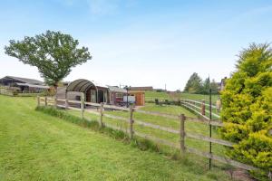 a farm with a fence and a train in a field at 1 Bed in Hereford oc-81292 in Aconbury +20 photos